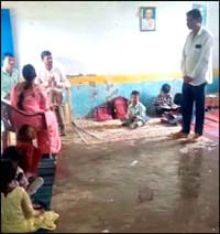 Forced to study in the open amid splashes of water